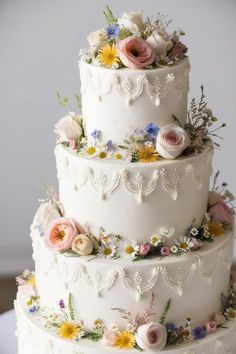 a three tiered wedding cake with flowers on it