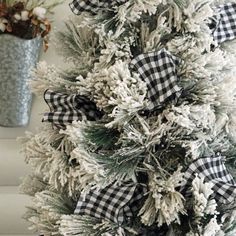 a white christmas tree with black and white bows