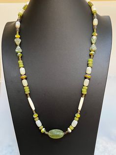 OLIVIA:  necklace of heartwarming greens in the lushness of nature;  a marriage of repetition and diversity of beads.  Delicate statement piece with a touch of boho, hippie, tribal.  Think of the buds of spring the olives of autumn.  A variety of Picasso premium beads, glass donut separators, and african green recycled glass. Green Long Spiritual Necklace, Green Spiritual Long Necklace, Spiritual Long Green Necklace, Unique Green Natural Stone Necklace, Nature-inspired Green Beaded Necklace With Round Beads, Green Nature-inspired Beaded Necklace With Round Beads, Green Spiritual Long Beaded Necklaces, Spiritual Green Long Beaded Necklaces, Green Natural Stones Long Necklace