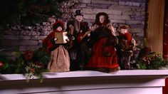 a group of figurines sitting on top of a mantle