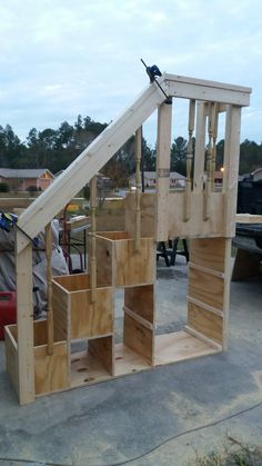 a wooden structure that is being built in the yard