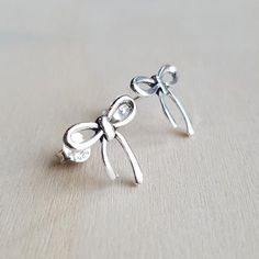 Check out this item in my Etsy shop https://www.etsy.com/listing/754488439/ribbon-bow-stud-earrings-925-sterling Tiny Classic Silver Earrings, Tiny Silver Classic Earrings, Adjustable Delicate Silver Earrings, Delicate Sterling Silver Earrings In Silver, Classic Silver Earrings For Gift, Classic Silver Earrings As Gift, Nickel-free White Gold Earrings Gift, Nickel-free White Gold Earrings For Gifts, Nickel-free White Gold Earrings