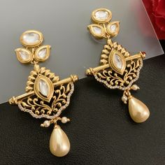 Fashionable and stylish, this pair of 18K Gold Plated Kundan Earrings will make you shine and stand out. This color works well with a variety of outfits. You can wear them with traditional outfits, western outfits, indo-western outfits, or casual gatherings. Best for gifting or for personal use, wear it to any occasion and be the spotlight. Eye-catching and unique jewelry that will set you apart. Gift this piece to a loved one, and see their face light up with joy. Length ~ 5 cm Party Chandbali Plug Earrings, Chandbali Plug Earrings For Party, Festive Danglers With Intricate Design, Traditional Chandbali Clip-on Earrings, Traditional Gold Clip-on Earrings For Party, Diwali Drop Earrings Danglers, Heavy Bridal Earrings For Eid, Elegant Kundan Jhumkas For Eid, Bollywood Style Intricate Jhumkas For Formal Events