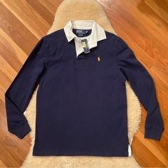 A Great Vintage Long Sleeve Navy Blue Polo With Fleece Lining And Quilted Yoke And Elbow Patches. New With Tags. Smoke-Free Home. See Pictures For Measurements. Navy Long Sleeve Tops For Layering, Navy Polo Collar Top For Winter, Navy Polo Collar Top For Fall, Classic Blue Tops For Layering, White Short Sleeve Shirt, Grey Polo Shirt, Green Polo Shirts, Slim Fit Polo Shirts, Rugby Polo