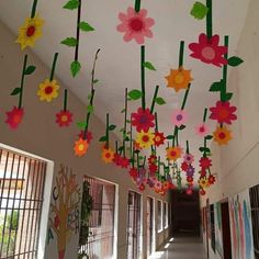 paper flowers hanging from the ceiling in a hallway