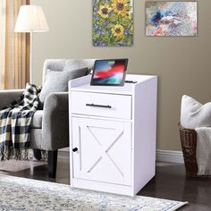 a living room scene with focus on the end table and laptop computer sitting on it