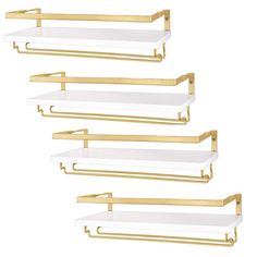 three white shelves with gold handles on each shelf