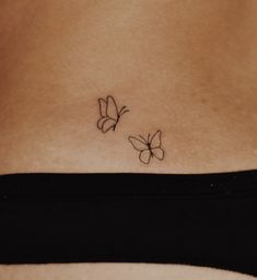 two butterflies on the back of a woman's stomach