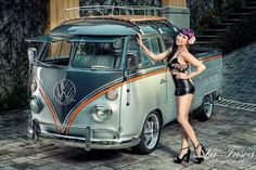 a woman standing next to an old vw bus