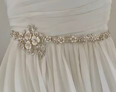 "Unique and romantic.  This enamel floral bridal wedding sash is accented with tons of sparkling crystals. This Delicate wedding belt beautifully compliments  your Boho, rustic or woodland wedding look.  READY TO SHIP  DETAILS * Design measures aprox. 2.25' wide (at widest part by 14\" long. * Offered in silve Metal or or Gold Metal *  Attached at ends to imported French satin ribbon in choice of colors View my complete collection including Bridal Sashes, Bridal Headpieces, Fascinators, Cuff Bra Elegant White Sashes For Ceremony, Elegant White Ceremony Sashes, Elegant Bridal Belt With Flower Decoration, Elegant Bridal Belt With Flower Decoration For Wedding, White Bridal Sash Belt For Bridesmaid, White Bridal Belt With Sashes For Bridesmaid, White Embellished Sashes For Wedding, Cream Bridal Belt With Sashes For Wedding, Elegant White Bride Sashes