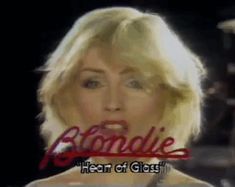 a woman with blonde hair is looking at the camera