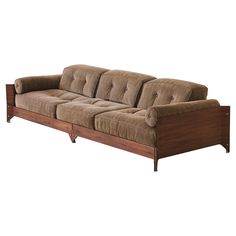 a brown couch sitting on top of a wooden frame