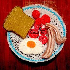 a plate with eggs, bacon, toast and fruit on it that says eat at