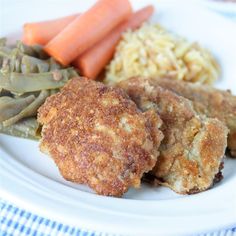 a white plate topped with meat and veggies