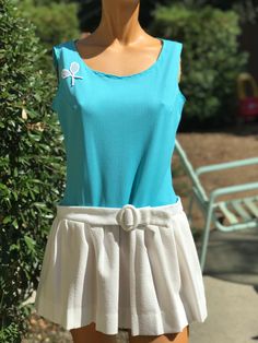 Here is a vintage 1970s tennis dress.Following are the measurements. Bust 36",waist 32",Hips full with pleats,length 29".Made out of polyester fabric .Bodice is a solid stripe turquoise fabric. Skirt has pleats with a belt.In nice vintage condition. Please take special consideration of measurements. 1970s sizing was very small to today's standards. Tennis dresses were very short not like a regular dress. So please take special note of length. If you live overseas please email me first before purchasing for mailing cost. Price quoted is for USA only Vintage Tennis Dress, Summer Tennis Dress With Pleated Skirt, Pleated Tennis Dress For Summer, Blue Spring Tennis Dress, Summer Pleated Tennis Dress, Blue Accordion Pleated Dress For Summer, Blue Sleeveless Spring Tennis Dress, Blue Sleeveless Tennis Dress For Spring, Blue Summer Dress With Accordion Pleats