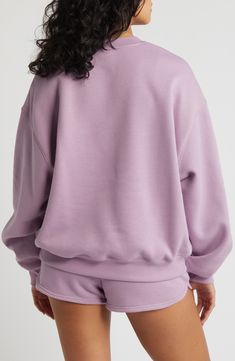 Washed and faded like an old favorite, this sweatshirt made of a cotton blend sports a roomy, slouchy fit that's perfect for layering. 25" length (size Medium) Crewneck 60% cotton, 40% polyester Machine wash, tumble dry Imported Heather Crew Neck Sweatshirt For Loungewear, Heather Crew Neck Sweatshirt With Ribbed Cuffs, Oversized Purple Sporty Tops, Sporty Oversized Purple Tops, Lavender Relaxed Fit Tops For Loungewear, Heather Relaxed Fit Sweatshirt For Loungewear, Oversized Lavender Cotton Top, Sporty Heather Cotton Sweatshirt, Purple Cotton Crew Neck Sweatshirt