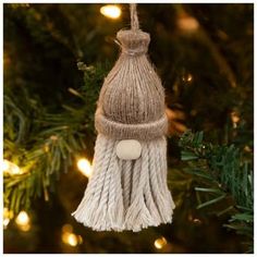 a tasseled ornament hanging from a christmas tree