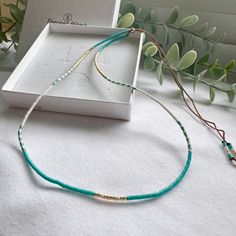 A beautifully dainty adjustable silk necklace with tiny turquoise and gold seed beads. Wear it solo or layer with others to create your unique bohemian look. It's the perfect addition to your summer accessories and a popular beach necklace.  We recommend layering with our Tiny Turquoise seed bead necklace: https://precioushippieuk.etsy.com/listing/1263330156 Hand-threaded on quality silk cord (beige colour) and secured with a 14k Gold filled slider bead. At its shortest this necklace is 16inches, it is adjustable up to 26 inches and will fit over your head. Your hippie style necklace will come in gift ready packaging. Explore more turquoise jewellery, mix and match from the Precious Hippie collection to create your unique stacks  https://precioushippieuk.etsy.com?section_id=49340267 Turquoise Seed Bead Necklace, Turquoise Jewellery, Silk Necklace, Beach Necklace, Turquoise And Gold, Beach Necklaces, Beige Colour, Necklace Turquoise, Silk Cord