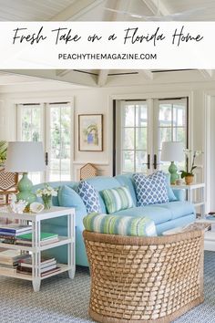 a living room with blue couches and wicker baskets on the coffee table in front of it