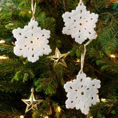 crocheted snowflake ornaments hanging from a christmas tree