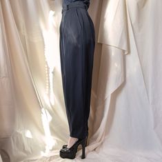 From YSL’s Rive Gauche line, these trousers are the perfect staple to add to your closet. The double button waistband and double pleats in the front allow for a comfortable yet incredibly flattering fit and the loose, almost wide leg cut of the trousers allow for easy styling with sneakers and heels alike. Beautiful and well-made, these are a great example of why people shop vintage. Size: FR 36, US 2/4 Composition: 100% wool Condition: Perfect, no visible stains, snags, holesMeasurements: Waist Formal Bottoms With Hidden Button Closure For Spring, Formal Spring Bottoms With Hidden Button Closure, Classic High-waist Bottoms With Pressed Crease, Classic High Waist Bottoms With Pressed Crease, Fall Tapered Leg Bottoms With Pressed Crease, Fall Bottoms With Pressed Crease And Tapered Leg, Classic Spring Pants With Hidden Button Closure, High Waist Pleated Bottoms With Loosely Fitted Hips, Tailored Tapered Leg Pants With Button Closure