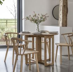 a wooden table and chairs in a room