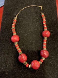 Broken clasp large red beaded necklace with small red and gold bead accents. 17 inches. Red Wooden Beaded Necklaces, Red Wooden Beaded Necklace, Red Costume Jewelry With Colorful Beads, Traditional Red Coral Beads, Red Coral Necklace With Gold Round Beads, Red Bohemian Large Beads, Red Coral Beaded Necklace With Wooden Beads, Red Beaded Costume Jewelry, Vintage Red Coral Necklace With Large Beads