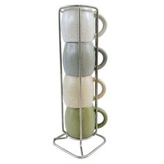 a metal rack holding four cups and saucers