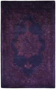 a purple rug with an intricate design on the center and bottom, in dark blue tones