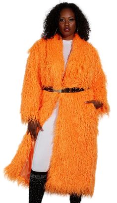 Introducing the Luxe Moda LM230 Church Coat, a garment that effortlessly combines style with comfort. This magnificent coat features a striking orange hue that is sure to turn heads and add a pop of color to any ensemble. Crafted from premium faux fur, the texture is both luxurious and eco-friendly, making it an exquisite choice for fashion-forward individuals. Designed to fall at a flattering mid-length, this coat provides ample coverage while still maintaining a sleek silhouette. Its loose fit ensures a comfortable wearing experience without restricting movement, making it perfect for a variety of occasions from formal church services to festive evening events. The open front and soft inner lining enhance the coat's cozy feel, while side pockets add a practical touch, allowing you to kee Long Orange Outerwear For Spring, Oversized Orange Outerwear For Spring, Spring Oversized Orange Outerwear, Long Orange Spring Outerwear, Long Orange Outerwear For Fall, Orange Long Sleeve Outerwear For Spring, Fitted Orange Long Sleeve Outerwear, Oversized Orange Outerwear For Work, Chic Fitted Orange Outerwear