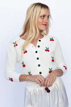 The Sweet Cherry Pie Cardigan features a light weight textured knit fabrication with cherry, button down front and semi cropped length. Goes perfectly pair with denim, over dresses and as a layering piece. Color: Ivory/Red Textured Knit With Cherry Applique Button Down Front Long Sleeve Acrylic Blend Model Wearing Is Wearing Sizes Medium and is 5'4, 32B Bust One Size Fits Most Cream Cardigan With Buttons For Spring, Spring Cream Sweater With Button Closure, Spring Knit Sweater With Button Closure, Knit Sweater With Button Closure For Spring, Cream Button Closure Sweater For Spring, Spring Knit Sweater With Buttons, Spring Pointelle Knit Cardigan For Day Out, Spring Cotton Button-up Sweater, Spring Button-up Cotton Sweater