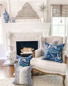 a living room filled with furniture and a fire place in front of a white fireplace