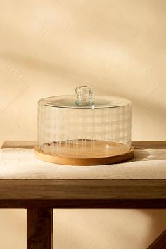 a glass container sitting on top of a wooden table