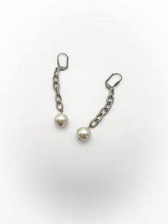 Pretty vintage dangle faux pearl earrings! Top is silver tone metal that is shaped like a shell with 6 link chain drop that has a faux pearl at the very end. Backings are meant for pierced ears and have a clip backing. No makers mark. Overall good condition. Minor wear and tarnish, free of rust and verdigris. Length of 2 and 5/8 inches. Discounts offered for bulk purchases. Shop accepts PayPal, credit cards, and Etsy gift cards. ♥Check out the rest of the shop♥ https://www.etsy.com/shop/artdecod Party Pearl Earrings With Metal Charm, Party Pearl Charm Earrings, Silver Party Pearl Earrings With Pearl Chain, Silver Pearl Chain Earrings For Party, Metal Drop Earrings With Pearl Chain, Silver Metal Clip-on Earrings With Pearl Drop, Silver Clip-on Earrings With Pearl Drop, Silver Earrings With Pearl Chain For Evening, Silver Pearl Chain Earrings For Evening