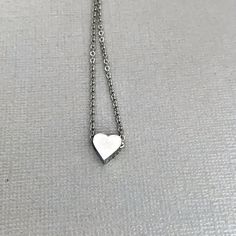 Dainty heart necklace is lightweight and perfect for everyday wear! A tiny, chunky stainless steel heart charm hangs from a fine stainless steel chain, which fastens with lobster clasp. Necklace is available in 3 lengths. Stainless steel will not tarnish, and is a great alternative for those with a sensitivity to metal! All items are carefully wrapped and packaged. In order to remain environmentally friendly, I only include a box when requested. Gift wrap is also available to purchase, and your Minimalist Stainless Steel Heart Charm Jewelry, Hypoallergenic Heart-shaped Stainless Steel Jewelry, Hypoallergenic Heart Necklace For Valentine's Day, Hypoallergenic Heart Shaped Stainless Steel Necklace, Silver Stainless Steel Heart Necklace, Simple Silver Heart Charm Necklaces, Simple Silver Heart Charm Necklace, Minimalist Nickel-free Heart Pendant Necklace, Everyday Stainless Steel Necklace For Mother's Day