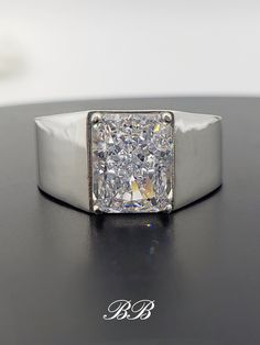 a diamond ring sitting on top of a table