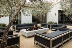 an outdoor seating area with couches and fire pit