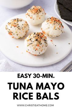 three white rice balls on a plate with text overlay that reads easy 30 - min tuna mayo rice balls