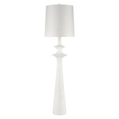 a white floor lamp with a shade on it