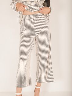 The Holland Pinstripe Pants are the perfect combination of comfort and style! Their pinstriped design adds a touch of sophistication, while the matching blazer offers versatility. The flowy fit ensures a flattering fit for any body type. Elevate your business casual wardrobe with these must-have pants! Details Thick Stretchy Waistband Pinstriped Wide Leg Cropped Length Size recs: 2-4 Small, 6-8 Medium, 10 Large Provides stretch Spring Relaxed Fit Bottoms With Vertical Stripes, Spring Striped Wide Leg Pants With Relaxed Fit, Straight Pants With Vertical Stripes For Spring, Spring Straight Pants With Vertical Stripes, Summer Workwear Bottoms With Striped Hem, Spring Wide Leg Pants With Vertical Stripes, Ankle-length, Wide Leg Ankle-length Pants With Vertical Stripes For Spring, Spring Ankle-length Wide Leg Pants With Vertical Stripes, Spring Pants With Vertical Stripes And Relaxed Fit