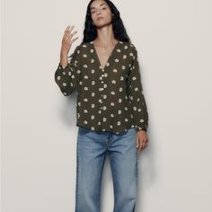 Long Sleeve V-Neck Top. Contrast Embroidery Detail. Front Button Closure. 7973/824 Casual V-neck Blouse With Button Closure, Relaxed Fit V-neck Blouse With Buttons, Casual Button-up Blouse With Floral Embroidery, Casual Green Blouse With Floral Embroidery, Green Blouse With Floral Embroidery And Relaxed Fit, Green Button-up Top With Floral Embroidery, Chic Relaxed Fit Blouse With Floral Embroidery, Chic Floral Embroidered Relaxed Fit Blouse, Chic Floral Embroidered Blouse With Relaxed Fit