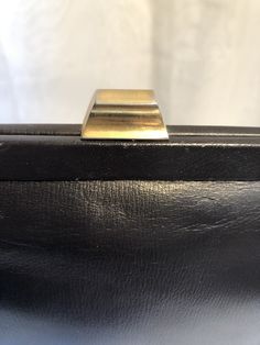 "*Excellent preowned 1960's condition , chocolate dark brown leather designer purse by DOFAN made in France * *Brass magnetic clasp closure and brass feet * double 15\" strap * inside zippered pockets & large outside slide pocket *very clean interior * *Measures 8\" high x 10\" wide"