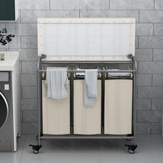 a washer and dryer sitting next to each other in front of a tiled wall