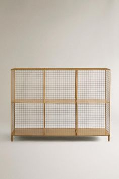 a wooden shelf with wire mesh on top