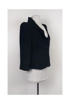 Head to the office in style with this chic blazer. Designed with a ruffle detail along the front and padded shoulders for structure. It pairs well with pencil skirts or trousers. Size 8 (IT 44) 72% acetate, 28% silk Made in Italy Button down front Padded shoulders Lined Long sleeve Ruffle detail on right side of collar Tiny pull on collar Bust 36" Waist 32" Shoulder to hem 21.5" Spring Blazer With Structured Shoulders And Fitted Cut, Spring Fitted Blazer With Structured Shoulders, Fitted Blazer With Structured Shoulders For Office, Spring Ruffled Blazer For Work, Chic Ruffled Blazer For Office, Chic Tailored Ruffle Blazer, Spring Blazer With Ruffles For Workwear, Chic Evening Blazer With Ruffles, Black Fitted Blazer With Structured Shoulders