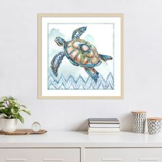 a painting of a sea turtle is hanging on the wall above a white dresser and sideboard