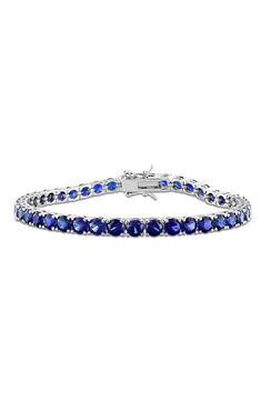 Round-cut lab-created blue sapphires are prong-set along this timeless tennis bracelet. 7 1/4" inner circumference; 1/8" width Total lab-created-blue-sapphire weight: 14.50ct. Sterling silver/lab-created blue sapphire Imported Blue Tennis Bracelet With Prong Setting For Formal Occasions, Silver Sapphire Tennis Bracelet With Brilliant Cut, Blue Brilliant Cut Tennis Bracelet For Gift, Blue Brilliant Cut Tennis Bracelet Gift, Blue Round Tennis Bracelet With Prong Setting, Blue Tennis Bracelet With Prong Setting, Classic Blue Sapphire Diamond Bracelet, Blue Diamond Bracelet In Prong Setting, Blue Diamond Bracelet With Prong Setting