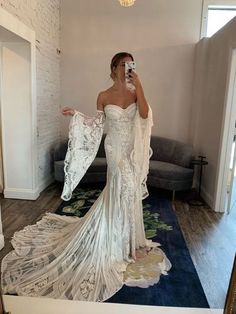 a woman taking a selfie in her wedding dress