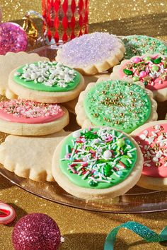 decorated cookies on a platter with confetti and sprinkles