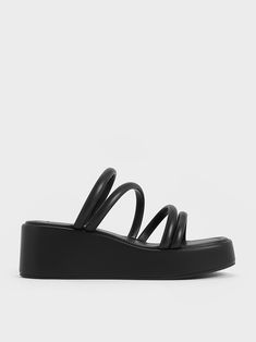 You will want to reach for these effortlessly stylish platform wedges every day. Featuring a comfortable, slip-on format with tubular straps across the vamps, the design puts a contemporary spin on the classic strappy sandals. With a sleek black finish, they will complement most outfits with ease. Fitted on platform wedge soles that give a nod to Y2K trends, they will boost both height and comfort - wear them with a denim miniskirt and tank to really embrace the noughties look. Y2k Trends, Denim Miniskirt, Faux Leather Heels, Size Chart For Kids, Charles Keith, Black Platform, Comfort Wear, Black Wedges, Platform Wedge